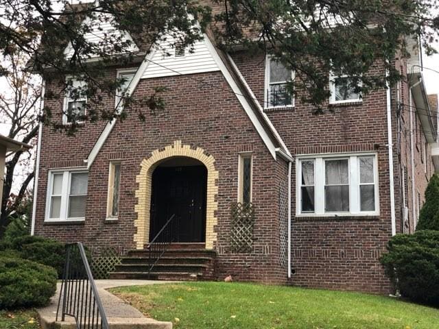 79 Mundy Ave, Staten Island, NY 10310 - tudor-style house featuring brick siding and a front yard