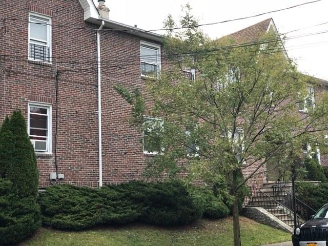79 Mundy Ave, Staten Island, NY 10310 - view of home's exterior featuring brick siding and a chimney