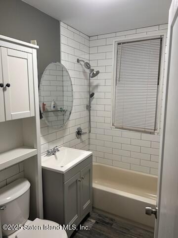 79 Mundy Ave, Staten Island, NY 10310 - full bathroom with toilet, vanity, washtub / shower combination, and wood finished floors