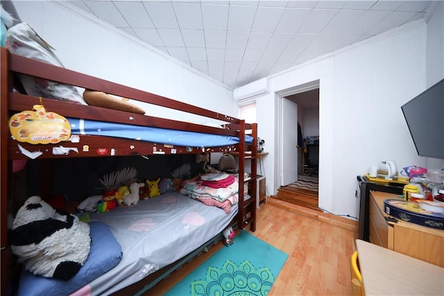 2144 W 6th St, Brooklyn, NY 11223 - bedroom with wood finished floors, crown molding, and a wall unit AC
