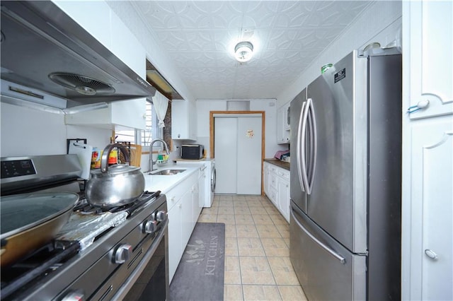 2144 W 6th St, Brooklyn, NY 11223 - kitchen with stainless steel appliances, under cabinet range hood, white cabinetry, a sink, and an ornate ceiling