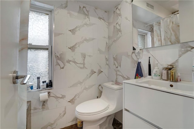 2823 Batchelder St, Brooklyn, NY 11235 - bathroom featuring tile walls, toilet, and vanity