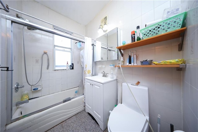2123 71st St, Brooklyn, NY 11204 - bathroom with vanity, enclosed tub / shower combo, toilet, speckle patterned floor, and tile walls