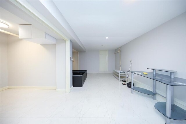 2123 71st St, Brooklyn, NY 11204 - finished basement featuring light marble finish flooring, baseboards, and recessed lighting