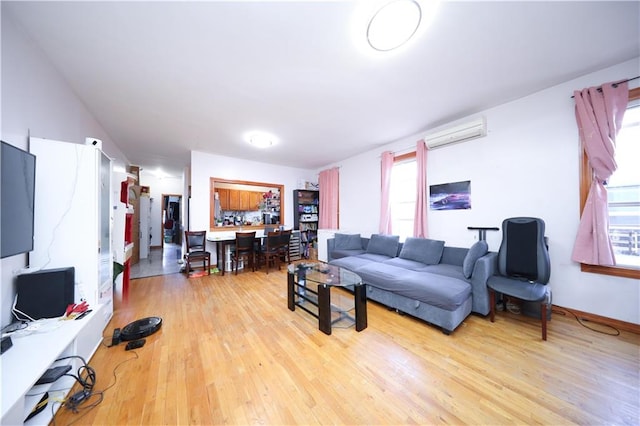 2123 71st St, Brooklyn, NY 11204 - living area featuring a wall unit AC and light wood-style flooring