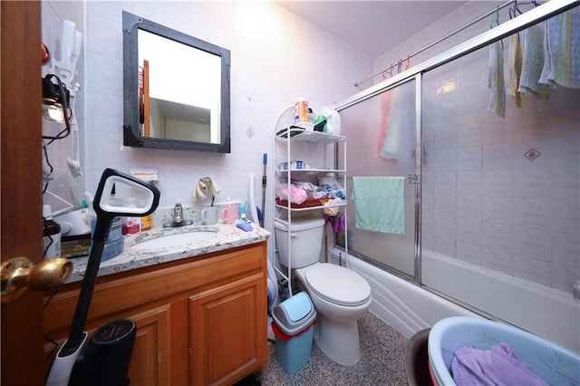 2123 71st St, Brooklyn, NY 11204 - bathroom featuring tile walls, vanity, bath / shower combo with glass door, and toilet