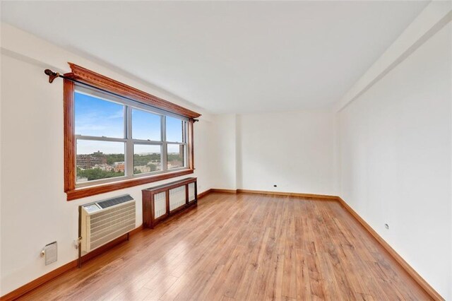 2483 W 16th St Unit 10K, Brooklyn, NY 11214 - spare room featuring light wood-style floors and a wall mounted air conditioner