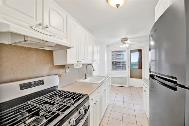 2483 W 16th St Unit 10K, Brooklyn, NY 11214 - kitchen featuring appliances with stainless steel finishes, under cabinet range hood, a ceiling fan, white cabinetry, and light countertops