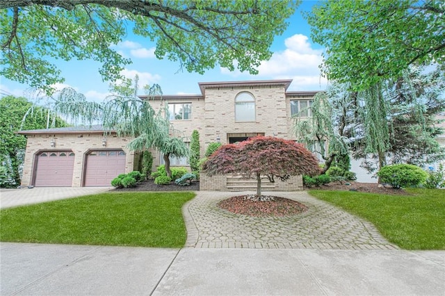34 Burton Ave, Staten Island, NY 10309 - view of front facade with decorative driveway, a front lawn, and brick siding