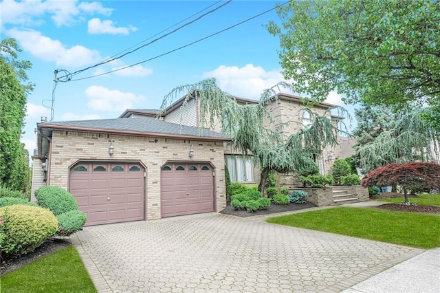 34 Burton Ave, Staten Island, NY 10309 - view of front of house with an attached garage, decorative driveway, brick siding, and roof with shingles
