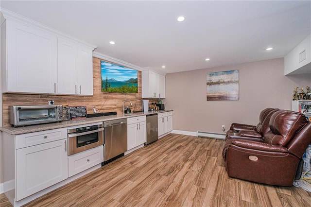 34 Burton Ave, Staten Island, NY 10309 - kitchen with appliances with stainless steel finishes, a baseboard heating unit, light wood-style flooring, white cabinetry, and recessed lighting