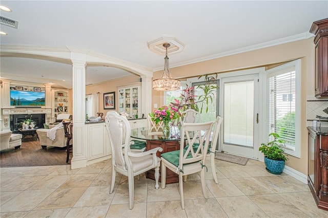 34 Burton Ave, Staten Island, NY 10309 - dining room featuring decorative columns, ornamental molding, a fireplace, and a chandelier