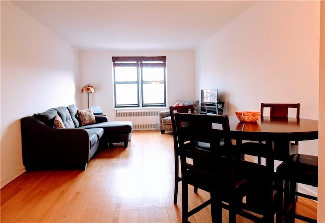 61 Oliver St Unit 5B, Brooklyn, NY 11209 - dining area with radiator heating unit and light wood-type flooring