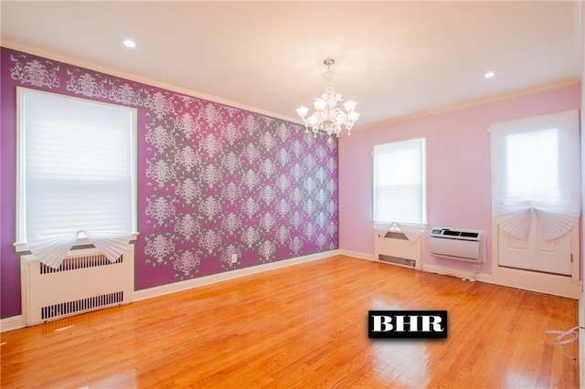 4060 Ocean Ave, Brooklyn, NY 11235 - unfurnished room featuring radiator heating unit, a chandelier, ornamental molding, an AC wall unit, and wood finished floors