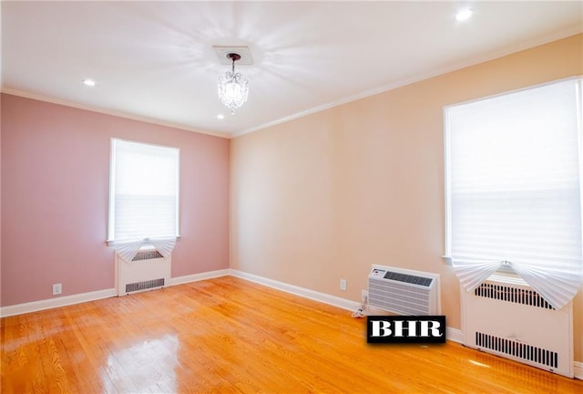 4060 Ocean Ave, Brooklyn, NY 11235 - empty room featuring a chandelier, light wood-style floors, crown molding, recessed lighting, and a wall unit AC