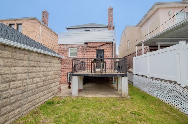 4060 Ocean Ave, Brooklyn, NY 11235 - back of property with brick siding, a wooden deck, and a yard