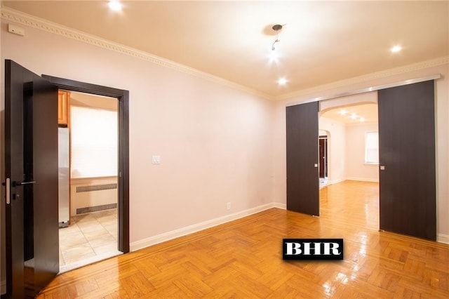 4060 Ocean Ave, Brooklyn, NY 11235 - empty room with radiator heating unit, arched walkways, and crown molding
