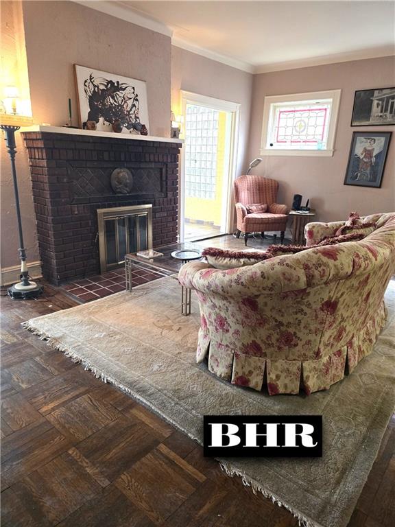 269 Coleridge St, Brooklyn, NY 11235 - living area with a brick fireplace, crown molding, and baseboards