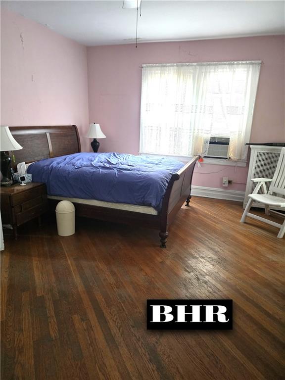 269 Coleridge St, Brooklyn, NY 11235 - bedroom featuring wood finished floors, cooling unit, and baseboards
