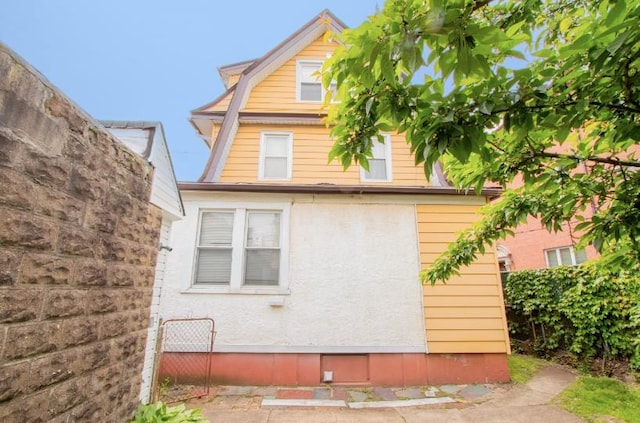 269 Coleridge St, Brooklyn, NY 11235 - view of side of property with a gambrel roof