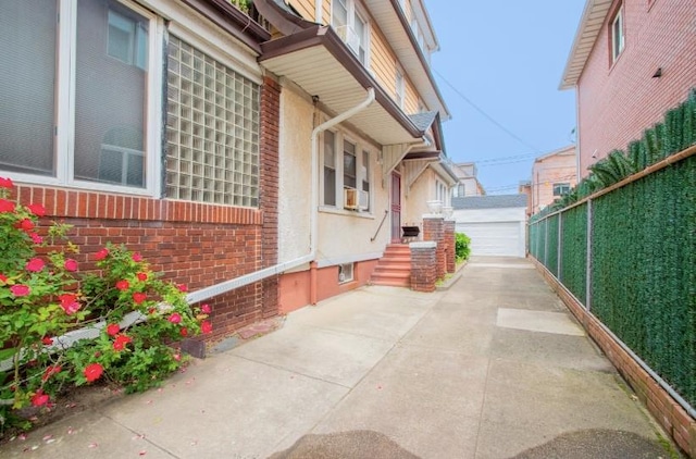 269 Coleridge St, Brooklyn, NY 11235 - view of property exterior with brick siding, a detached garage, and an outdoor structure