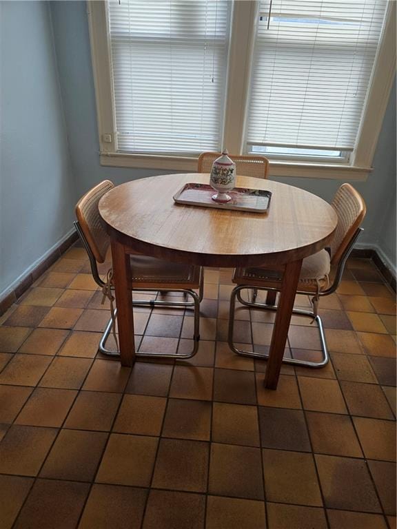 269 Coleridge St, Brooklyn, NY 11235 - dining space with baseboards and dark tile patterned floors