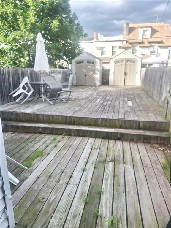 1675 72nd St, Brooklyn, NY 11204 - wooden terrace featuring a shed, a fenced backyard, and outdoor dining space