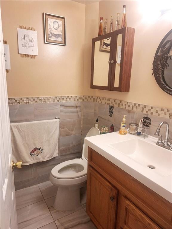 1675 72nd St, Brooklyn, NY 11204 - bathroom featuring tile walls, vanity, tile patterned flooring, and wainscoting