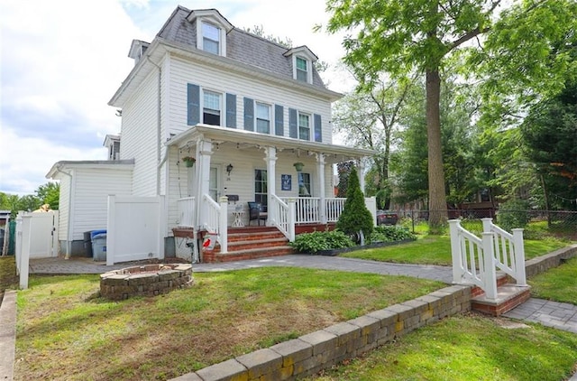 28 Trinity Pl, Staten Island, NY 10310 - second empire-style home with covered porch, a fire pit, mansard roof, and a shingled roof