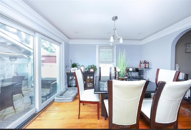 28 Trinity Pl, Staten Island, NY 10310 - dining space featuring arched walkways, wood finished floors, and ornamental molding