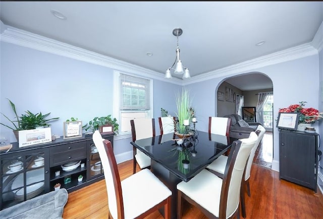 28 Trinity Pl, Staten Island, NY 10310 - dining room featuring crown molding, arched walkways, and wood finished floors