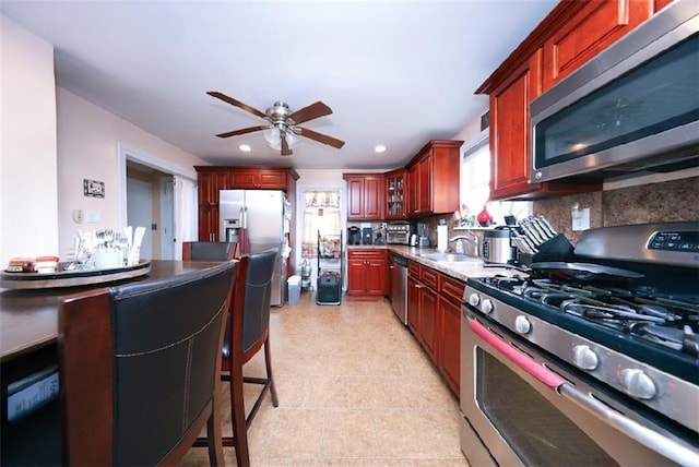 28 Trinity Pl, Staten Island, NY 10310 - kitchen with appliances with stainless steel finishes, ceiling fan, dark brown cabinets, recessed lighting, and backsplash