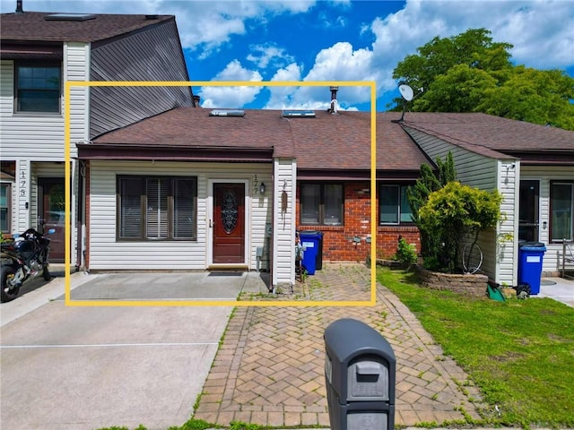 177 Russek Dr Unit 1, Staten Island, NY 10312 - view of property with brick siding, roof with shingles, and a front yard