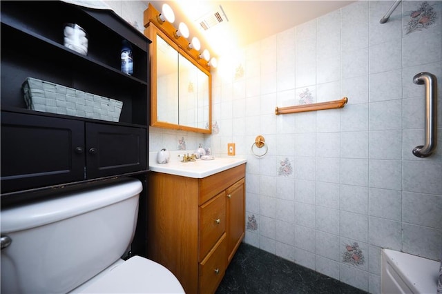 177 Russek Dr Unit 1, Staten Island, NY 10312 - full bathroom with toilet, vanity, and tile walls