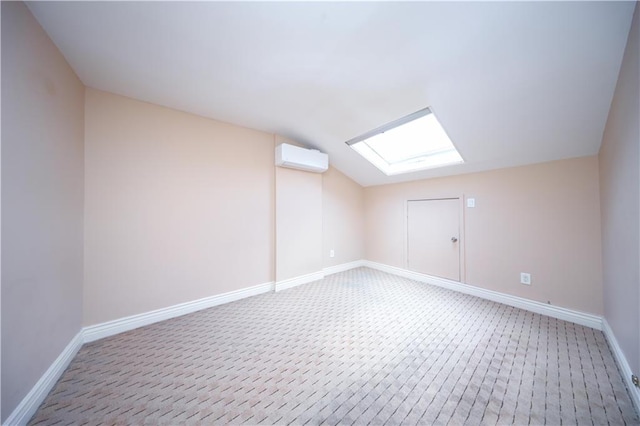 177 Russek Dr Unit 1, Staten Island, NY 10312 - additional living space featuring a skylight, baseboards, vaulted ceiling, a wall mounted AC, and light carpet
