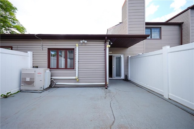 177 Russek Dr Unit 1, Staten Island, NY 10312 - rear view of house featuring a patio area, a cooling unit, and a chimney
