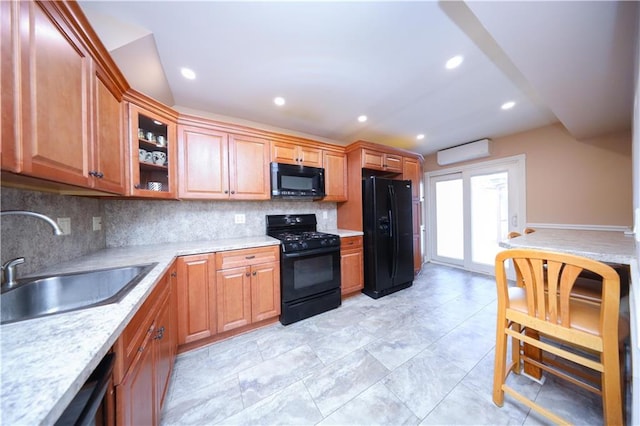 177 Russek Dr Unit 1, Staten Island, NY 10312 - kitchen featuring black appliances, a sink, a wall mounted AC, backsplash, and light countertops