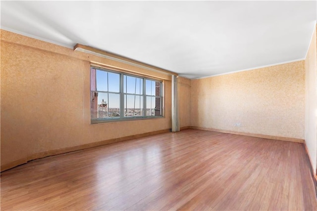2475 W 16th St Unit 9H, Brooklyn, NY 11214 - unfurnished room featuring light wood-type flooring, baseboards, and crown molding