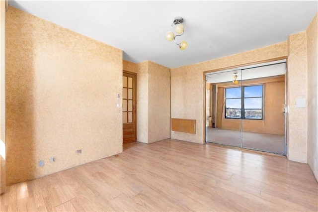 2475 W 16th St Unit 9H, Brooklyn, NY 11214 - unfurnished room featuring wood finished floors and wallpapered walls