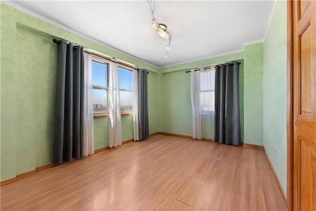 2475 W 16th St Unit 9H, Brooklyn, NY 11214 - unfurnished room with healthy amount of natural light, light wood finished floors, crown molding, and baseboards
