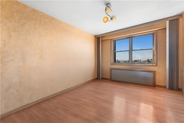 2475 W 16th St Unit 9H, Brooklyn, NY 11214 - spare room featuring light wood-style flooring and baseboards