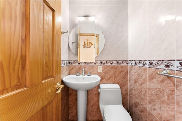 2475 W 16th St Unit 9H, Brooklyn, NY 11214 - half bath featuring tile walls, toilet, and a sink