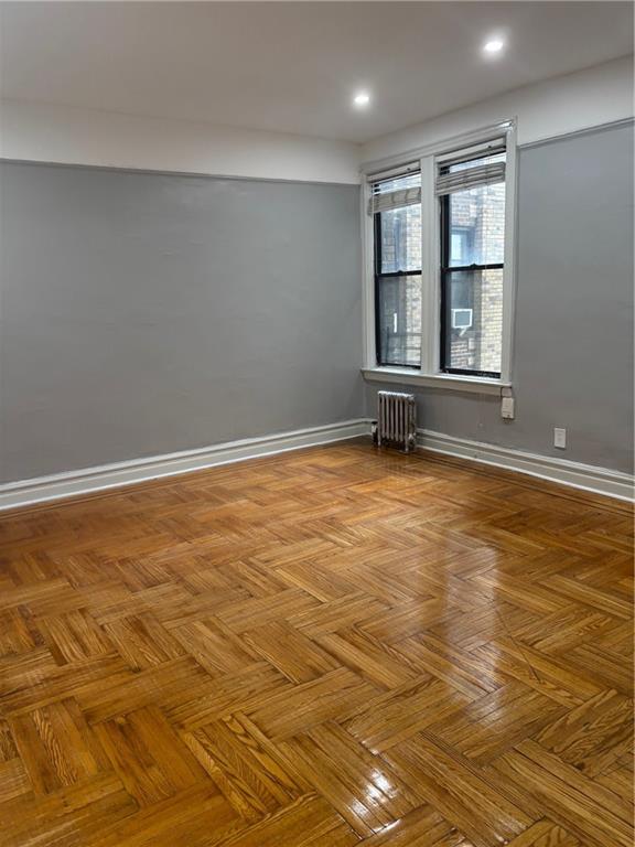 2020 E 41st St Unit 3H, Brooklyn, NY 11234 - unfurnished room featuring radiator, baseboards, and recessed lighting