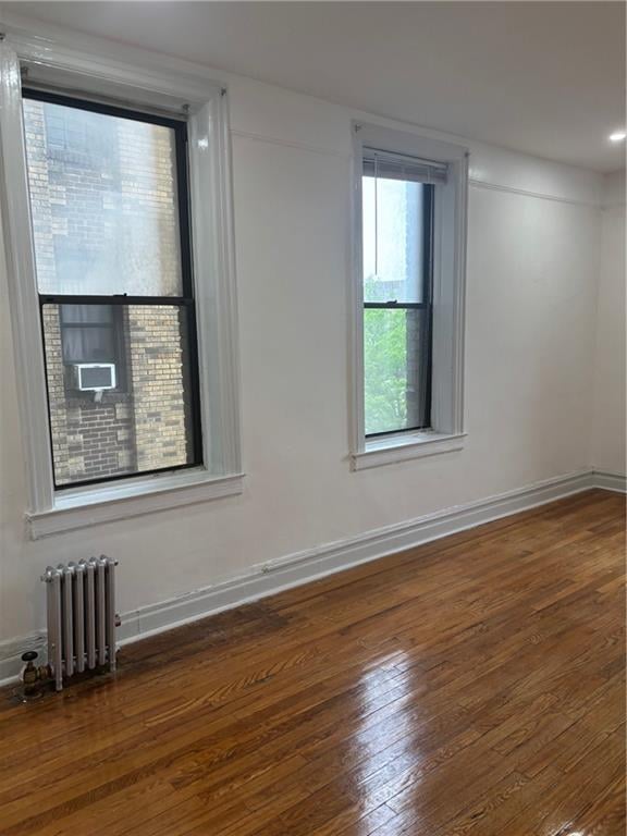 2020 E 41st St Unit 3H, Brooklyn, NY 11234 - unfurnished room featuring radiator heating unit, hardwood / wood-style flooring, and baseboards