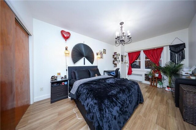 1711 Bay Ridge Parkway, Brooklyn, NY 11204 - bedroom with radiator heating unit, a chandelier, light wood-type flooring, and baseboards
