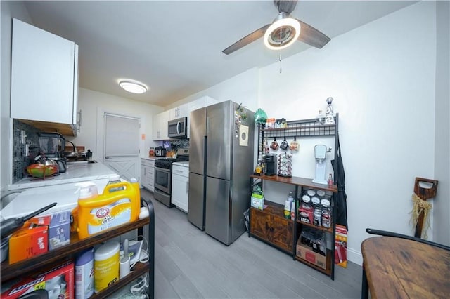 1711 Bay Ridge Parkway, Brooklyn, NY 11204 - kitchen with stainless steel appliances, white cabinetry, light wood-type flooring, and light countertops
