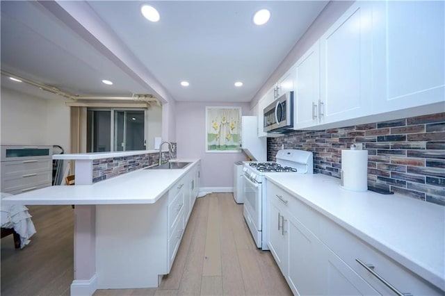 1711 Bay Ridge Parkway, Brooklyn, NY 11204 - kitchen with white gas range, stainless steel microwave, a peninsula, a sink, and recessed lighting
