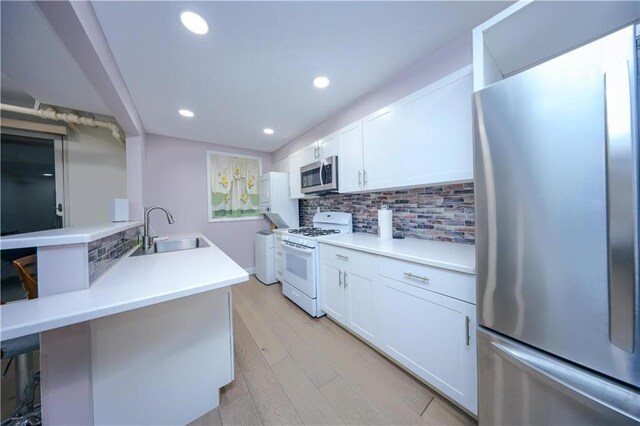 1711 Bay Ridge Parkway, Brooklyn, NY 11204 - kitchen featuring appliances with stainless steel finishes, a sink, backsplash, white cabinets, and recessed lighting