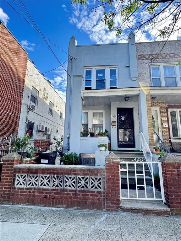 1414 76th St, Brooklyn, NY 11228 - view of front of house featuring stucco siding and a fenced front yard