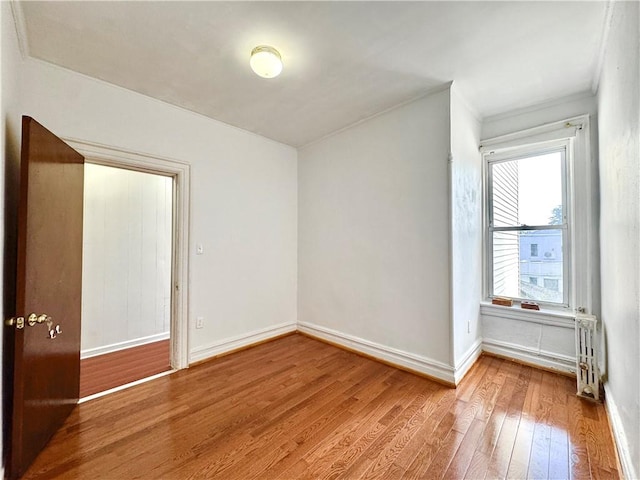 1414 76th St, Brooklyn, NY 11228 - empty room featuring wood finished floors, baseboards, and ornamental molding